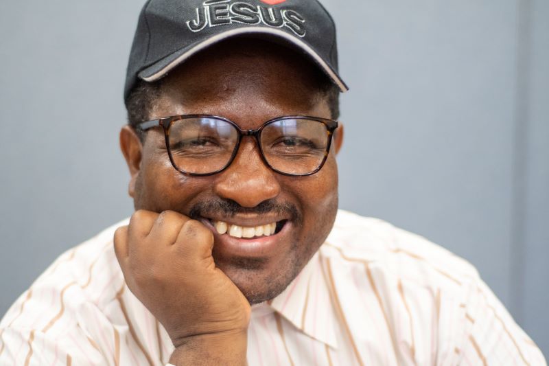 Cheerful person in striped shirt and hat