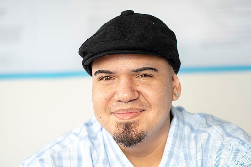 Person in casual attire, light background