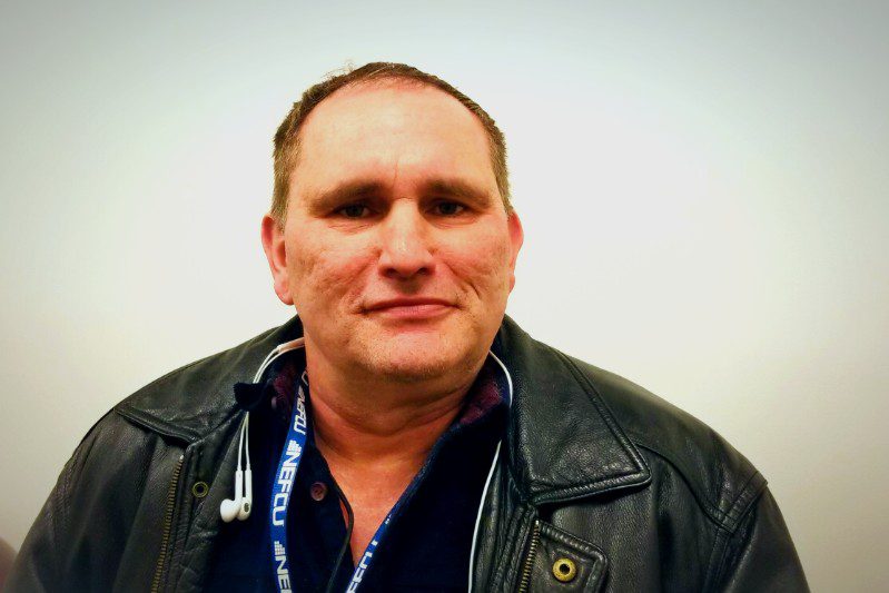 Person with lanyard and earphones